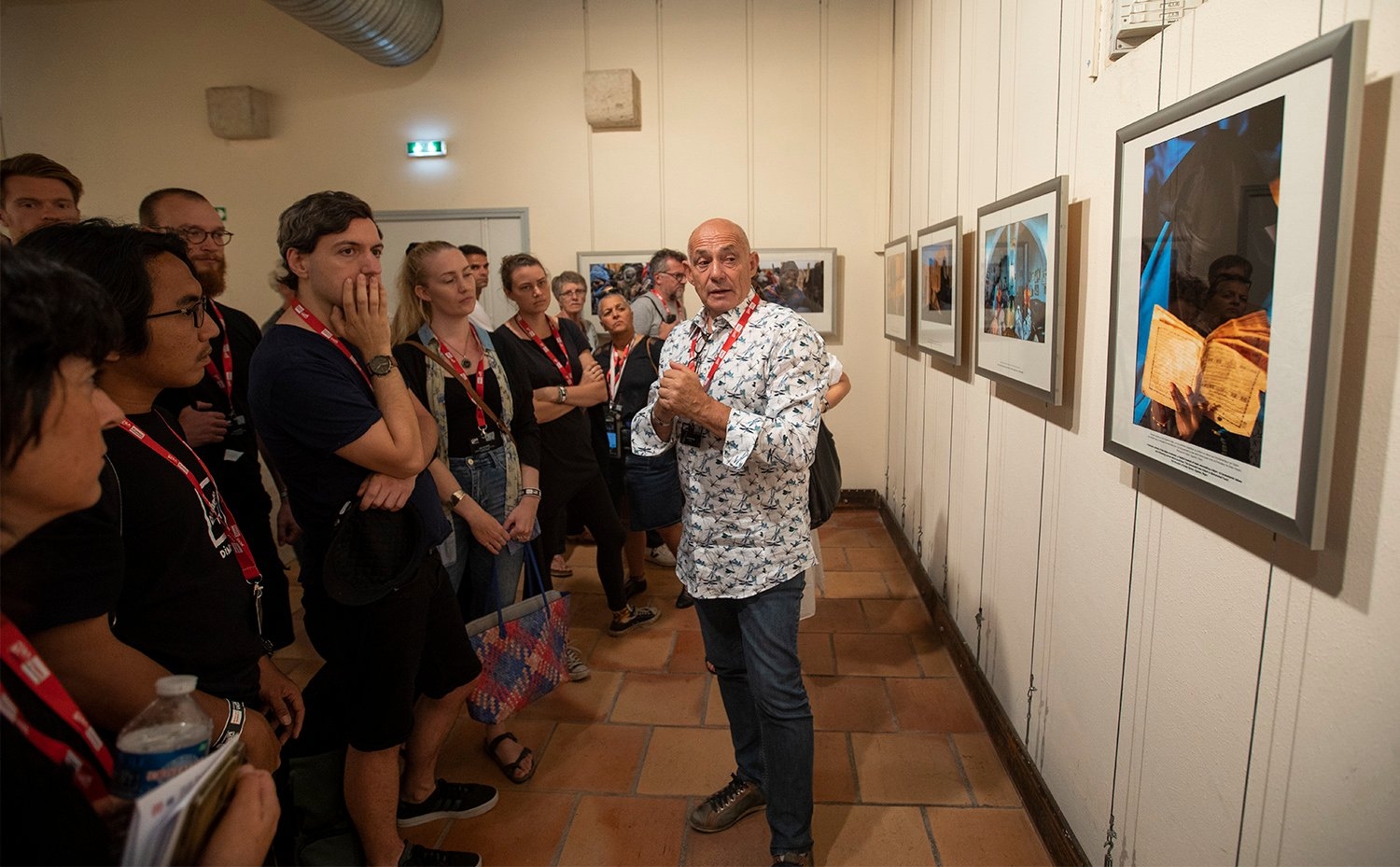 Pascal Maitre gives a tour of his exhibition, covering refugees crossing the Sahel desert. © Paul Hackett